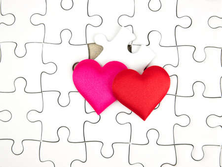 Colorful mini hearts on jigsaw puzzle pieces background, Valentine decorations, Various hearts.の写真素材