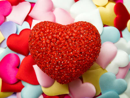 Red Heart on Colorful mini hearts background, Valentine decorations, Various hearts.
