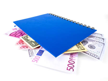 Blue book with nested international banknotes, isolated on white background. Stash of money concept, Business ideas.の写真素材