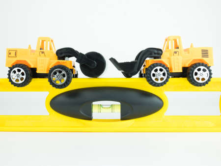 Toy Pressure road car and Bulldozer with building level on white background, Engineering...