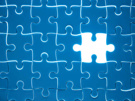 Missing Jigsaw puzzle piece with lighting, business concept for completing the finishing puzzle piece.の写真素材