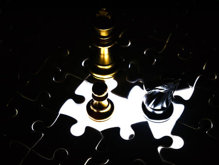 Gold and silver chess piece on jigsaw puzzle background, business concept.の写真素材
