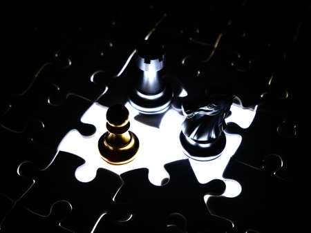 Gold and silver chess piece on jigsaw puzzle background, business concept.の写真素材