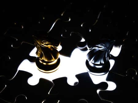 Gold and silver chess piece on jigsaw puzzle background, business concept.の写真素材