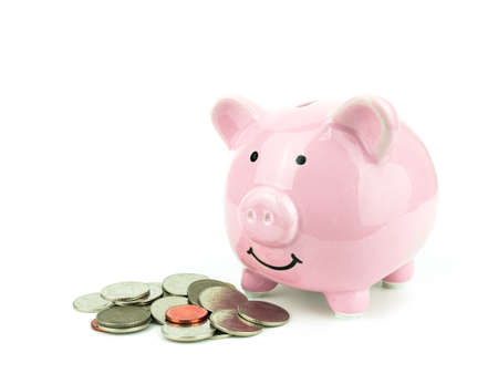 Pink piggy bank with money coins isolated on white background.の写真素材