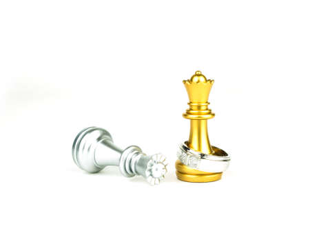 Diamond ring with golden and silver queen chess isolated on white background, Wedding Concept.の写真素材