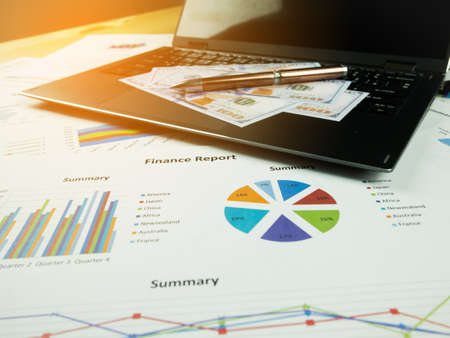 Business report chart and Financial graph analysis with dollar money and pen on the table.の写真素材