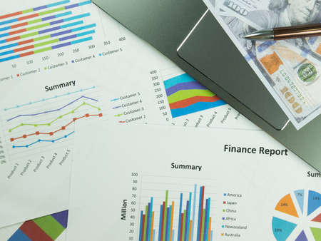 Business report chart and Financial graph analysis with dollar money and pen on the table.の写真素材