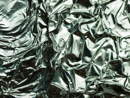 Silver foil with shiny crumpled texture background.の写真素材