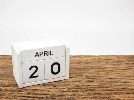 April 20 white wooden calendar on vintage wood and white background with Spring day, Copyspace for text.の写真素材