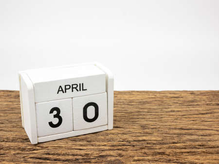 April 30 white wooden calendar on vintage wood and white background with Spring day, Copyspace for text.の写真素材