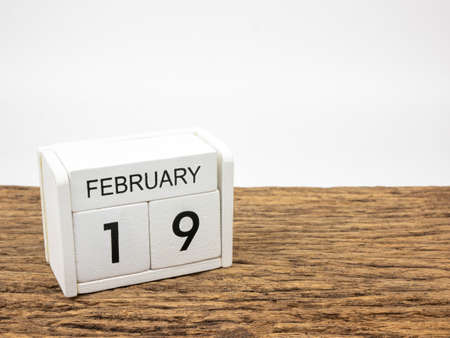 February 19 white cube wooden calendar on vintage wood and white background with winter day, Copyspace for text.の写真素材