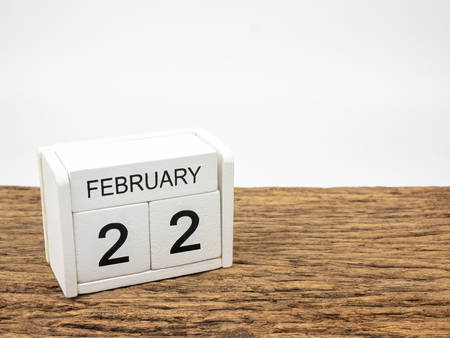 February 22 white cube wooden calendar on vintage wood and white background with winter day, Copyspace for text.の写真素材