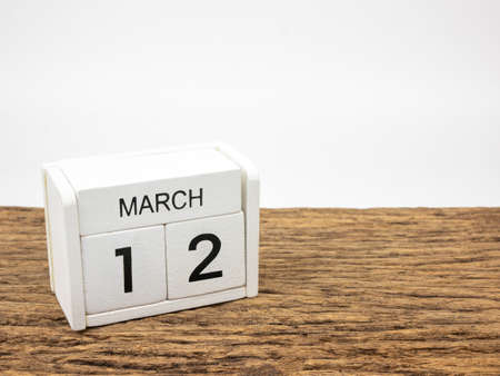 March 12 white cube wooden calendar on vintage wood and white background with Spring day, Copyspace for text.の写真素材