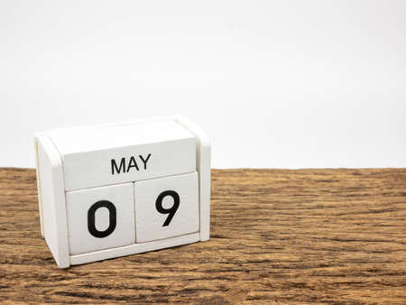 May 9 white wooden calendar on vintage wood and white background with Spring day, Copyspace for text.の写真素材