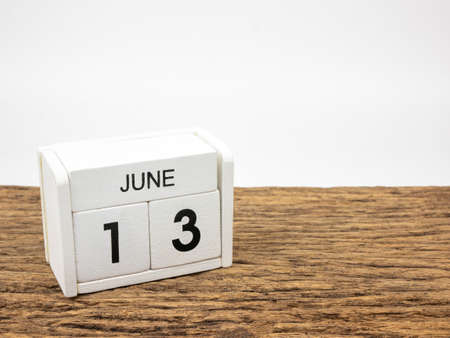 June 13 white cube wooden calendar on vintage wood and white background with Summer day, Copyspace for text.の写真素材