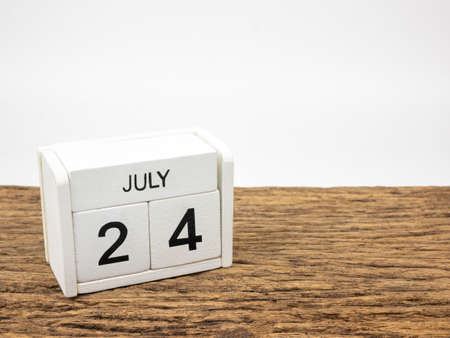 July 24 white cube wooden calendar on vintage wood and white background with summer day, Copyspace for text.の写真素材