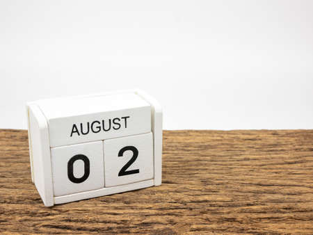 August 2 white cube wooden calendar on vintage wood and white background with summer day, Copyspace for text.の写真素材