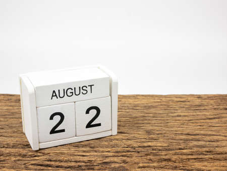 August 22 white cube wooden calendar on vintage wood and white background with summer day, Copyspace for text.の写真素材