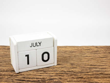 July 10 white cube wooden calendar on vintage wood and white background with summer day, Copyspace for text.の写真素材