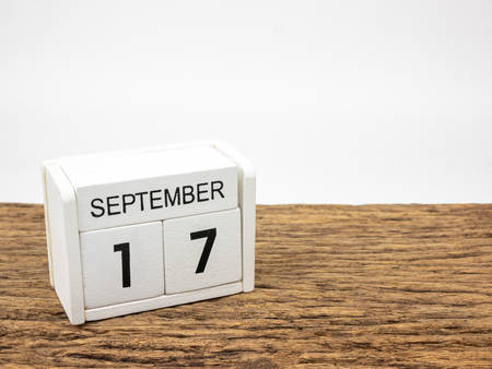 September 17 white cube wooden calendar on vintage wood and white background with autumn day, Copyspace for text.の写真素材
