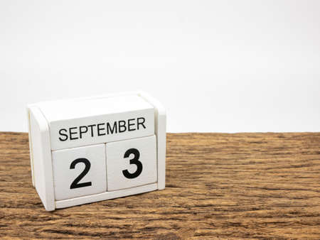 September 23 white cube wooden calendar on vintage wood and white background with autumn day, Copyspace for text.の写真素材