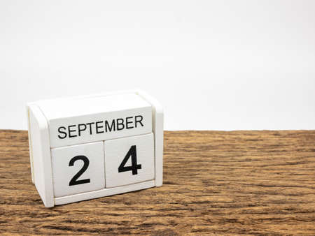 September 24 white cube wooden calendar on vintage wood and white background with autumn day, Copyspace for text.の写真素材