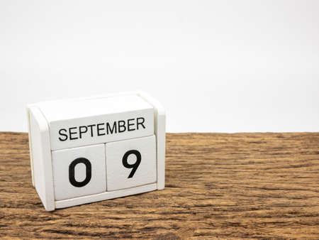 September 9 white cube wooden calendar on vintage wood and white background with autumn day, Copyspace for text.の写真素材