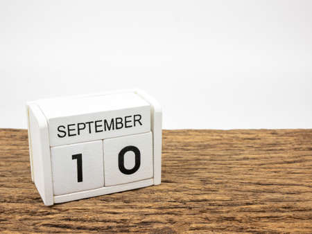 September 10 white cube wooden calendar on vintage wood and white background with autumn day, Copyspace for text.の写真素材