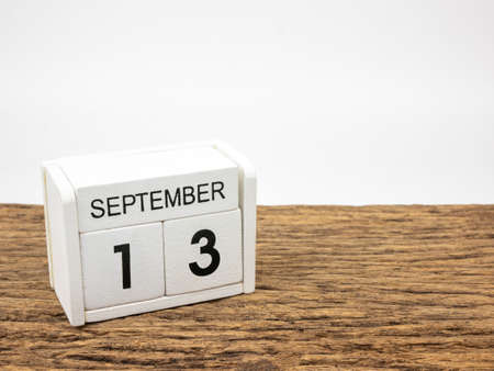 September 13 white cube wooden calendar on vintage wood and white background with autumn day, Copyspace for text.の写真素材