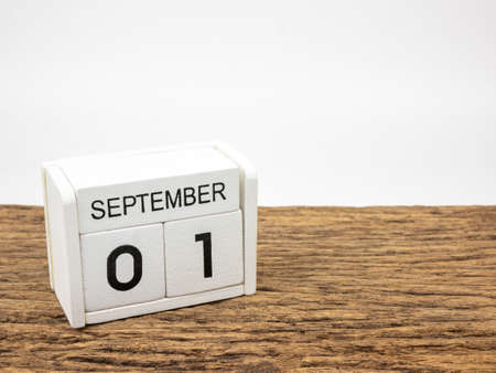 September 1 white cube wooden calendar on vintage wood and white background with autumn day, Copyspace for text.の写真素材