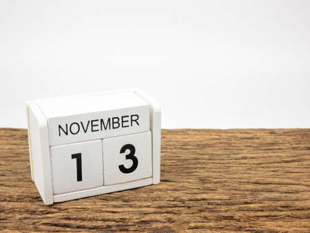 November 13 white cube wooden calendar on vintage wood and white background with autumn day, Copyspace for text.の写真素材