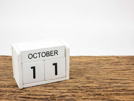 October 11 white cube wooden calendar on vintage wood and white background with autumn day, Copyspace for text.の写真素材