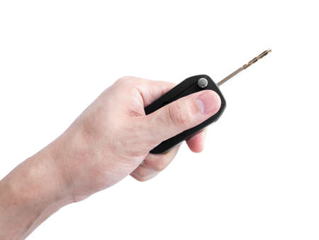 Man hand holding a car key remote isolated on white background, Clipping pathの写真素材