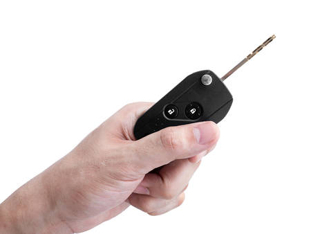 Man hand holding a car key remote isolated on white background, Clipping pathの写真素材
