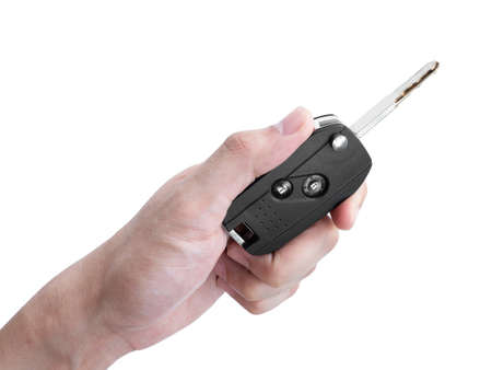 Man hand holding a car key remote isolated on white background, Clipping pathの写真素材