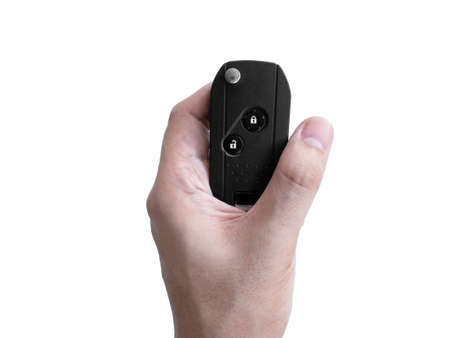 Man hand holding a car key remote isolated on white background, Clipping pathの写真素材
