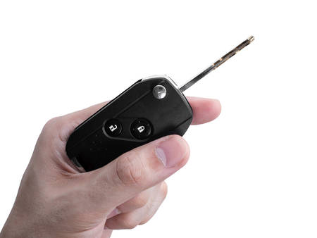 Man hand holding a car key remote isolated on white background, Clipping pathの写真素材