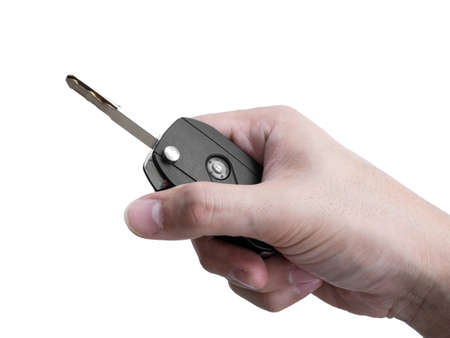 Man hand holding a car key remote isolated on white background, Clipping pathの写真素材