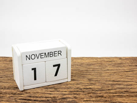 November 17 white cube wooden calendar on vintage wood and white background with autumn day, Copyspace for text.の写真素材