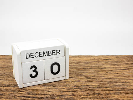 December 30 white cube wooden calendar on vintage wood and white background with winter day, Copyspace for text.の写真素材