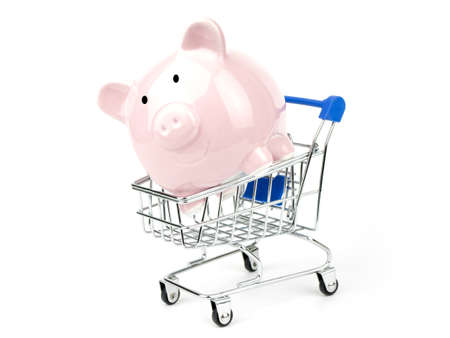 Save money shopping concept with piggy bank in a shopping cart,  isolated on white backgroundの写真素材