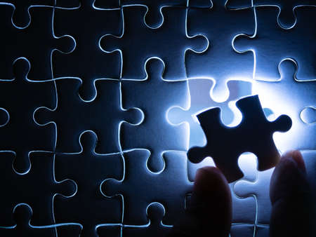 Missing Jigsaw puzzle piece with lighting, Business concept for completing the finishing puzzle piece.の写真素材