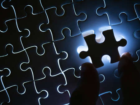 Missing Jigsaw puzzle piece with lighting, Business concept for completing the finishing puzzle piece.の写真素材