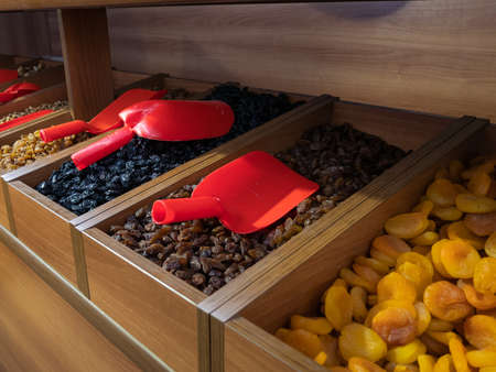 Close-up of different types of dried currants in a wooden box.の写真素材
