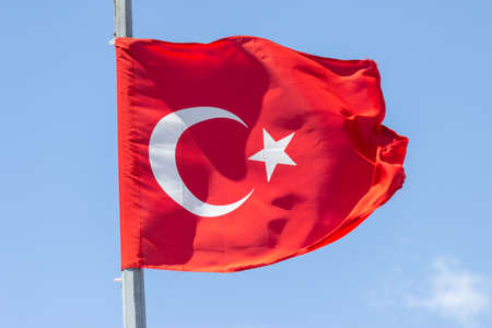 Turkey flag waving in the blue sky.の写真素材