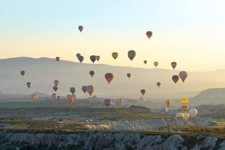 Colorful Hot air balloon flying over Red valley at Cappadocia, Anatolia, Turkey. Volcanic mountains in Goreme national park.の写真素材