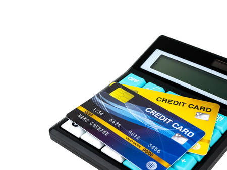 Credit card on calculator isolated on white background.の写真素材