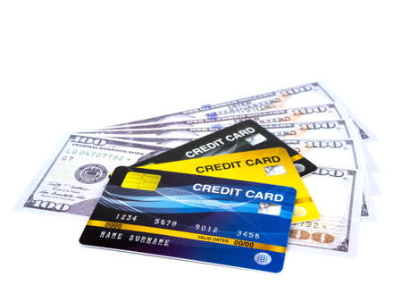 Credit card on american dollars cash isolated on white background.の写真素材