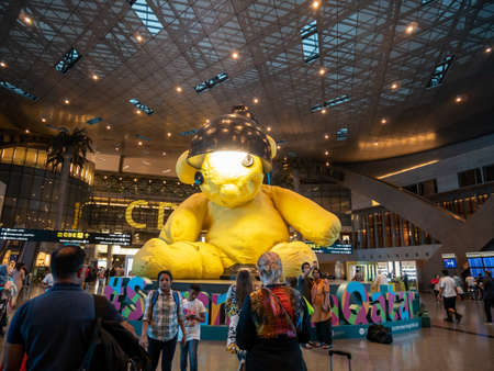 DOHA, QATAR - MAY. 31, 2019: Yellow Lamp bear at Hamad International Airport.のeditorial素材